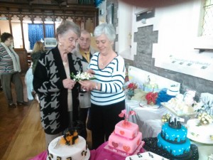 Margery Paton admiring a piece of sugarcraft with teacher Pat James