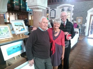 Colin Paton, Adele Cunningham and Graham Evans who run the Art Classes with some of the exhibits
